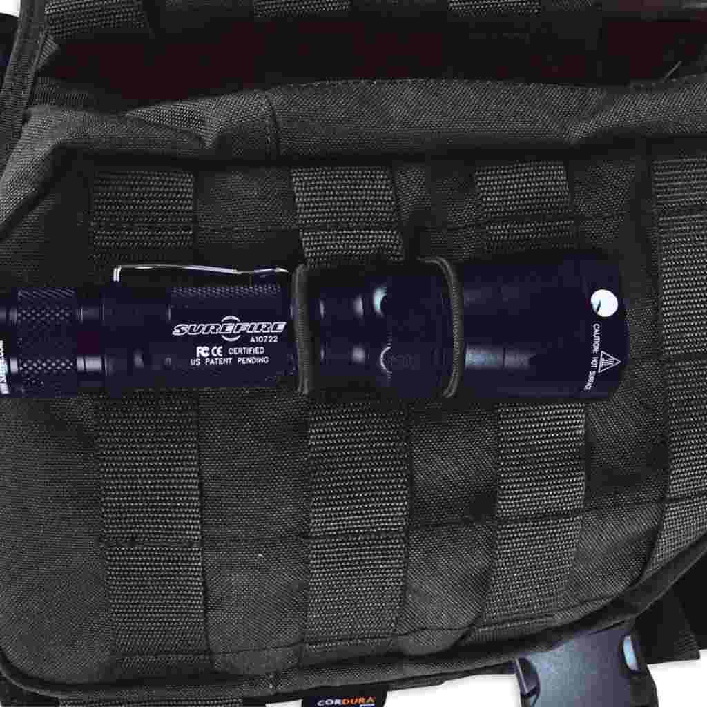 Close up of cable manager  in Molle system holding torch in place  - Black 