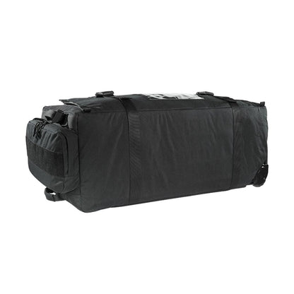 Left hand view of Tasmanian Tiger MIL Transporter, 190 litre deployment bag with large zipped accessible pocket, compression strap, handles at sides and small outside pouch - black