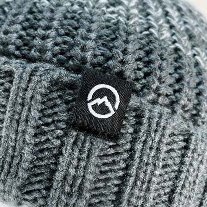 Close up of Domex logo on Grey ombre gradient cuffed beanie in a chunky knit