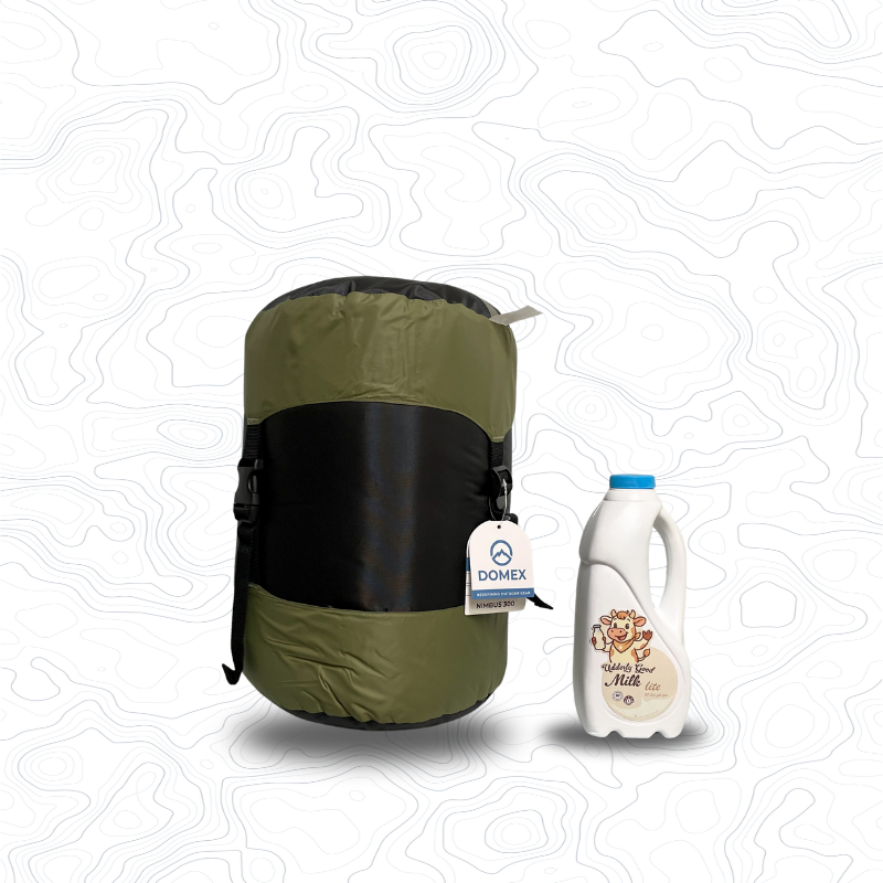Scale image of Domex Nimbus 300 Sleeping Bag | Upright in stuff sack next to 1 L bottle of milk