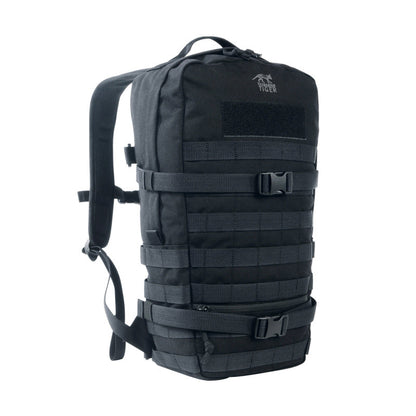 Three quarter front view of Tasmanian Tiger 15 litre daypack with small, flat zipped front pocket. It features two wraparound compression straps and a MOLLE system on the front and sides for individual expansion – Black. Ships Within New Zealand | TT7595.040