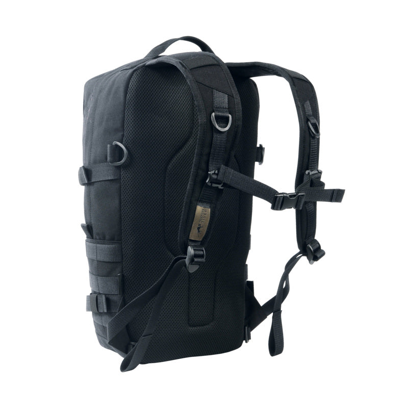 Three quarter back view of Tasmanian Tiger 15 litre daypack. It features adjustable harness with chest strap and two wraparound compression straps – Black | TT7595.040
