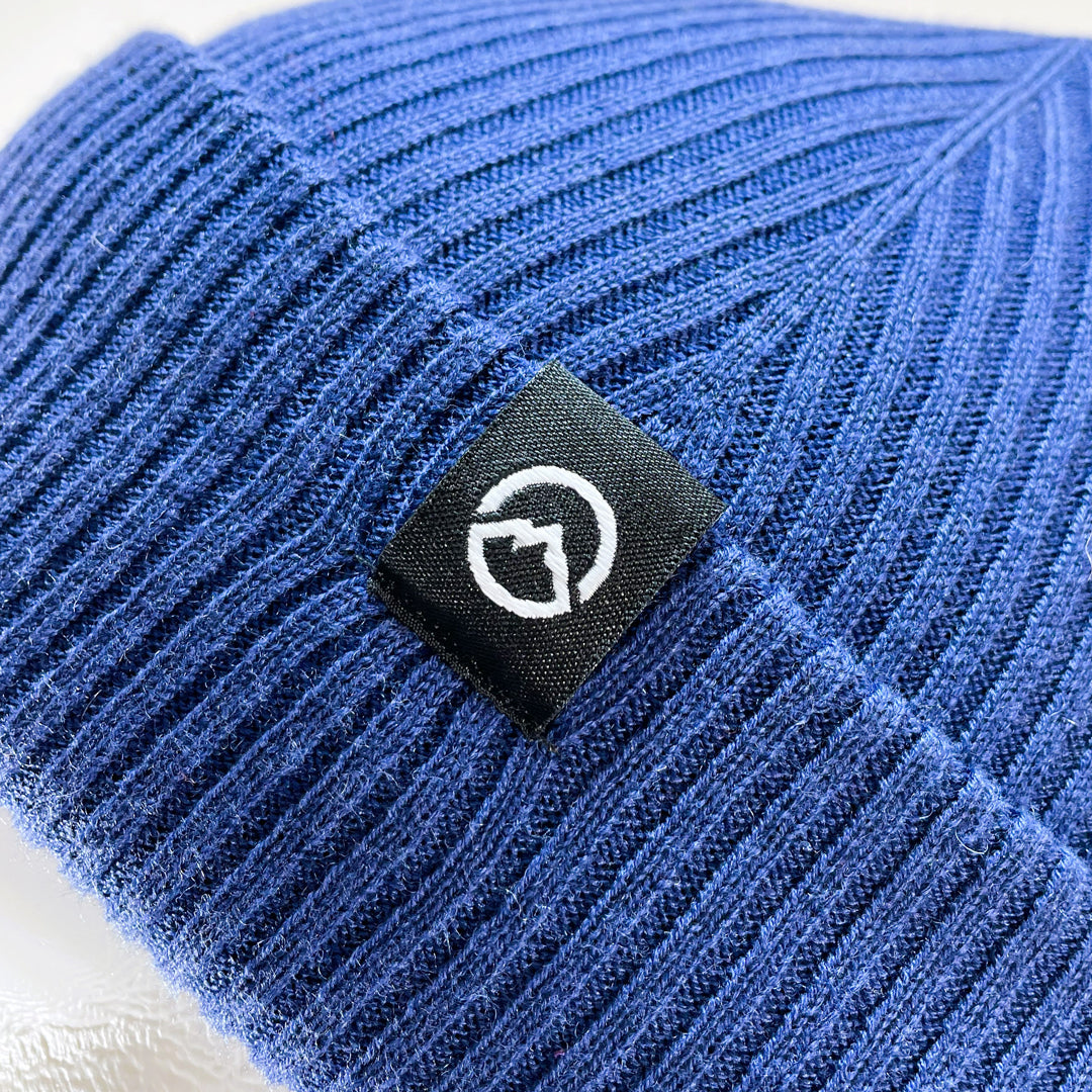 Close up of Logo on Domex wool-rich blend fine rib-knit Fisherman's beanie with cuffed hem - Polar blue | DOMB1050
