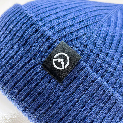 Close up of Logo on Domex wool-rich blend fine rib-knit Fisherman's beanie with cuffed hem - Polar blue | DOMB1050