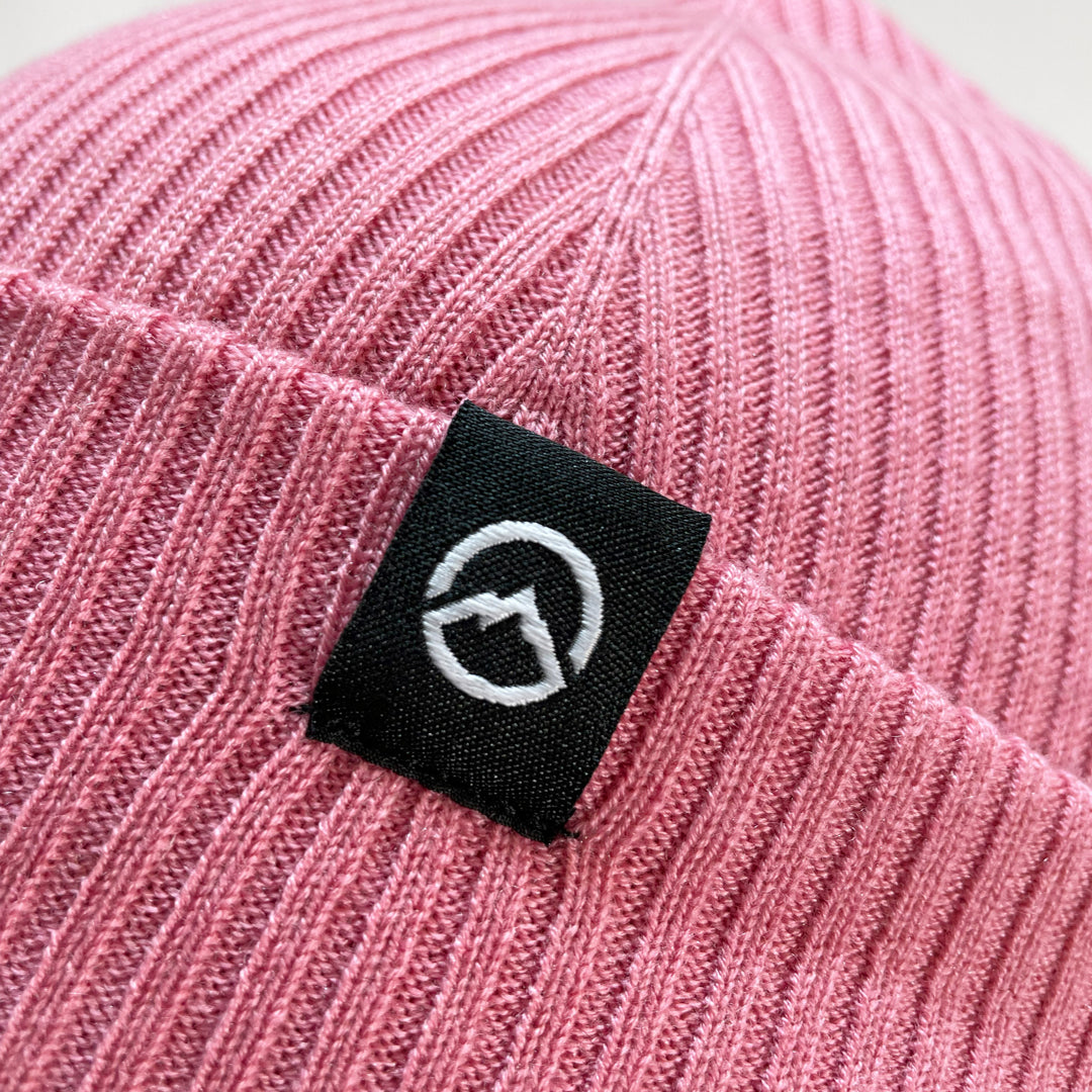 Close up of Logo on Domex wool-rich blend fine rib-knit Fisherman's beanie with cuffed hem - Dark Pink | DOMB1055