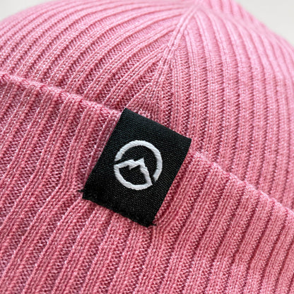 Close up of Logo on Domex wool-rich blend fine rib-knit Fisherman's beanie with cuffed hem - Dark Pink | DOMB1055