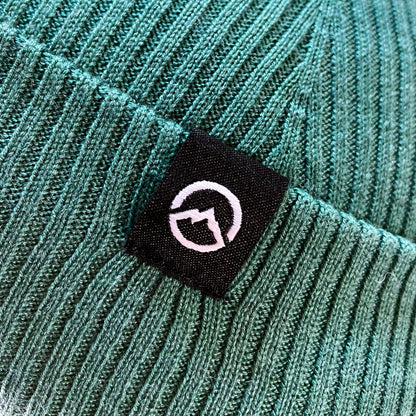 Close up of Logo on Domex wool-rich blend fine rib-knit Fisherman's beanie with cuffed hem - Sage Green | DOMB1040