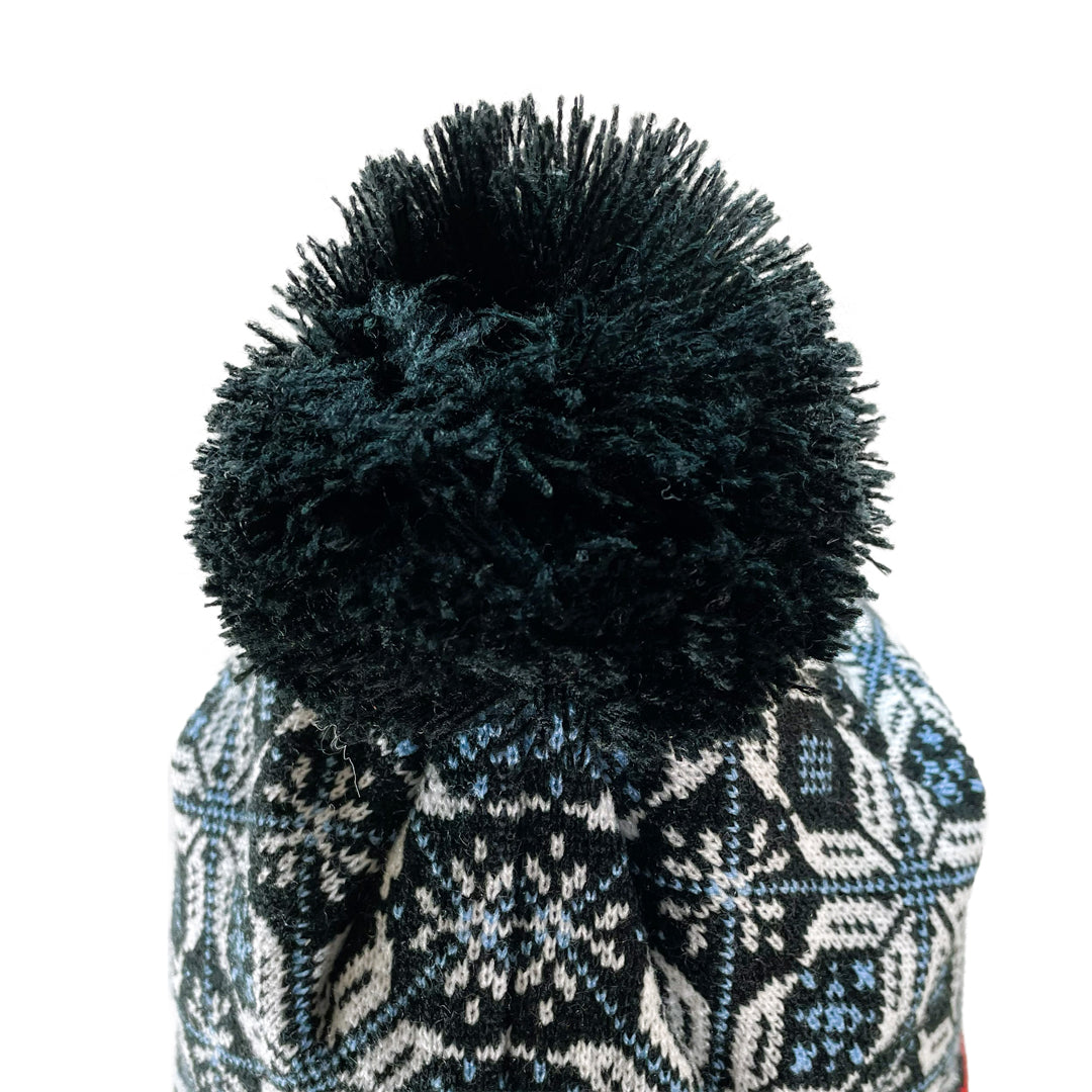 Close up of pom pom on Domex snowflake design cuffless knit beanie 