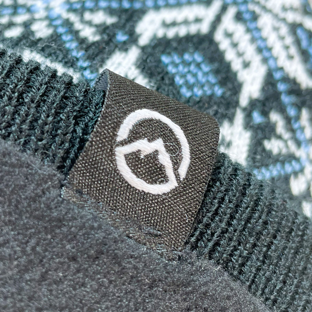 Close up of Domex logo on snowflake design cuffless knit beanie 