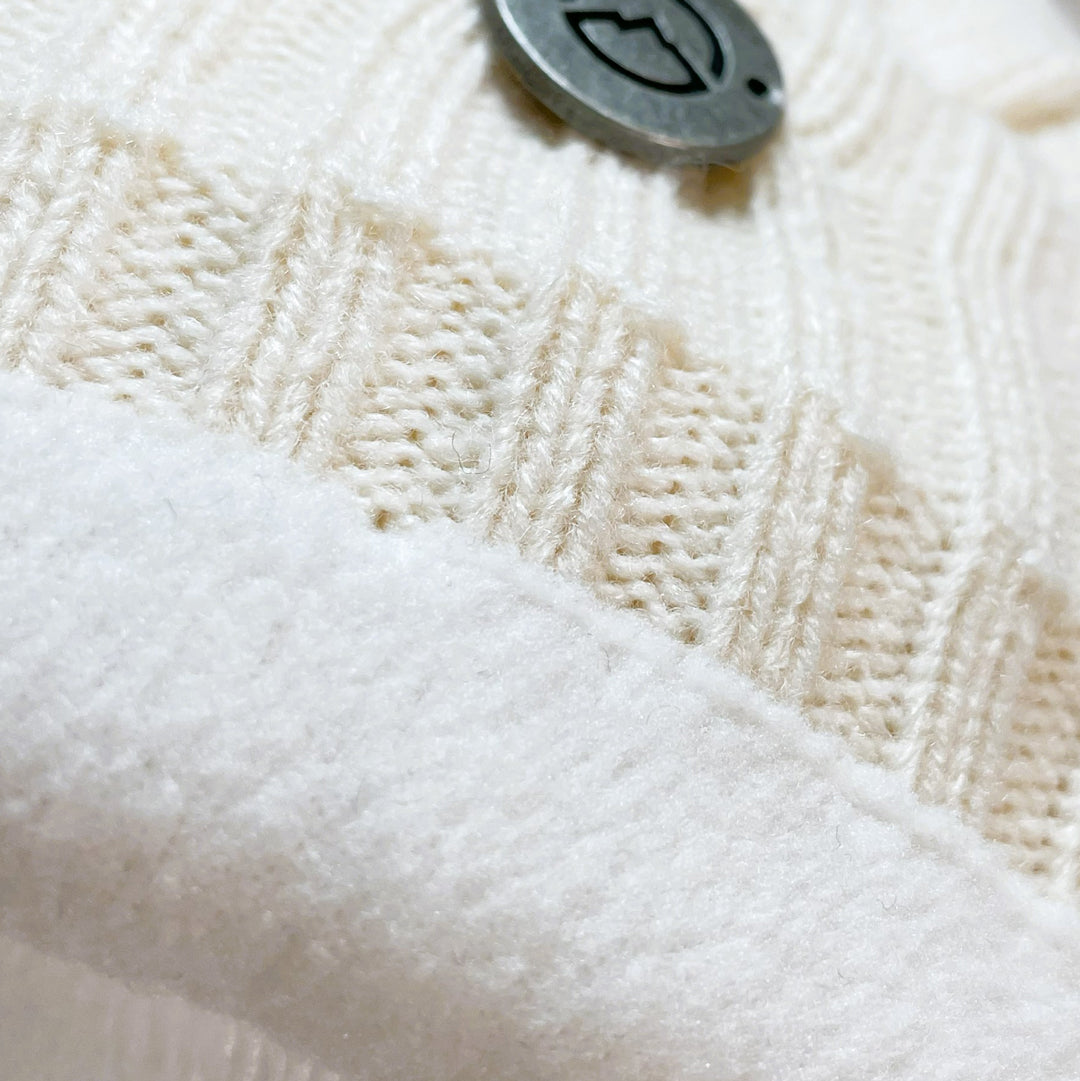 Close up of fleece lining of Domex White thick cable knit cuffed beanie 