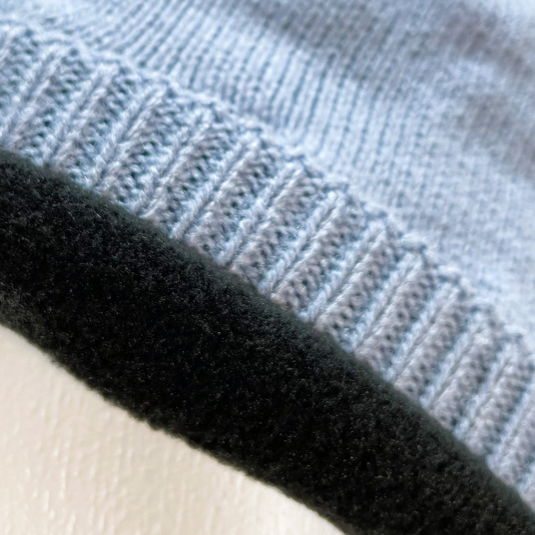 Close up of black fleece lining  of Domex Dusty blue skullcap beanie with accent woven cable knit band 
